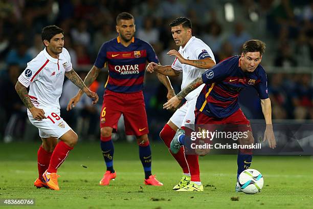 Lionel Messi of Barcelona breaks away from Jose Antonio Reyes of Sevilla during the UEFA Super Cup between Barcelona and Sevilla FC at Dinamo Arena...