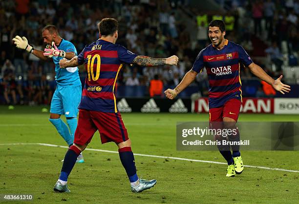 Lionel Messi of Barcelona celebrates with Luis Suarez of Barcelona after Rafinha of Barcelona scored their third goal during the UEFA Super Cup...