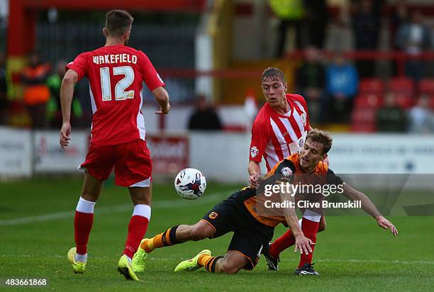 Nikica Jelavic of Hull City is tackled by Tom Davies of Accrington Stanley during the Capital One Cup First Round match between Accrington Stanley...