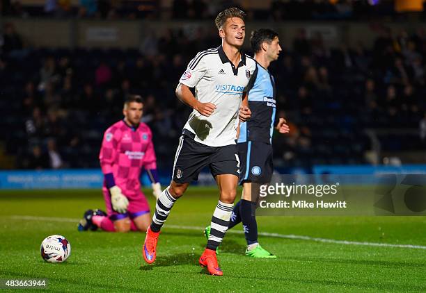 Despair for Wycomber players as Alex Kacaniklic of Fulham celebrates as he scores their first goal during the Capital One Cup first round match...