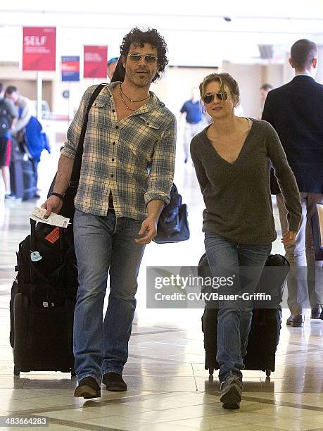 Renee Zellweger and Doyle Bramhall are seen at Los Angeles International Airport on February 15, 2013 in Los Angeles, California.