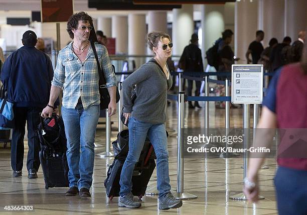 Renee Zellweger and Doyle Bramhall are seen at Los Angeles International Airport on February 15, 2013 in Los Angeles, California.