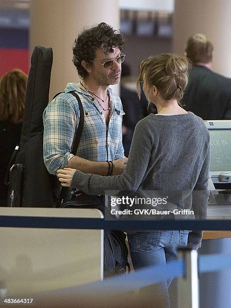 Renee Zellweger and Doyle Bramhall are seen at Los Angeles International Airport on February 15, 2013 in Los Angeles, California.