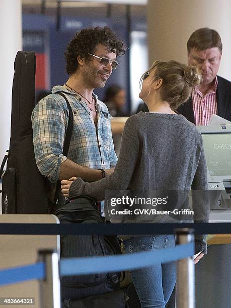 Renee Zellweger and Doyle Bramhall are seen at Los Angeles International Airport on February 15, 2013 in Los Angeles, California.