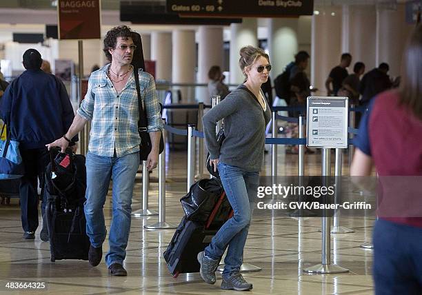 Renee Zellweger and Doyle Bramhall are seen at Los Angeles International Airport on February 15, 2013 in Los Angeles, California.