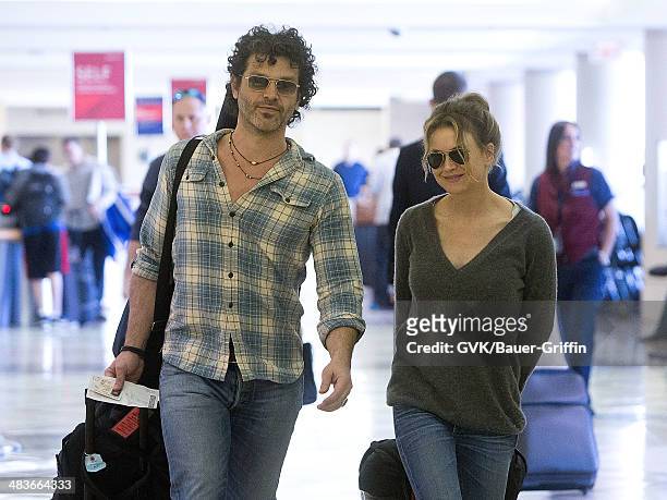 Renee Zellweger and Doyle Bramhall are seen at Los Angeles International Airport on February 15, 2013 in Los Angeles, California.