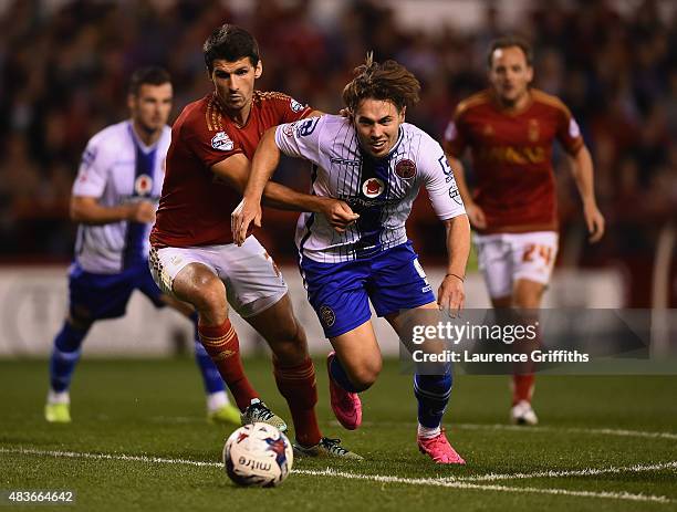 Eric Lichaj of Nottingam Forest battles with Tom Bradshaw of Walsall during the Capital One Cup First Round match between Nottingham Forest and...