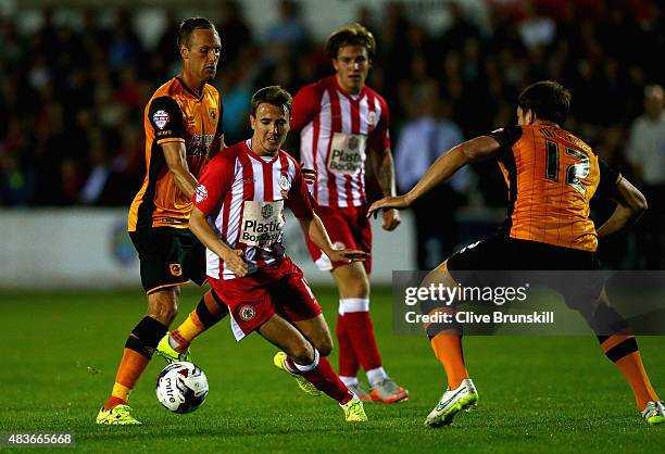Sean McConville of Accrington Stanley attempts to move past Harry Maguire of Hull City during the Capital One Cup First Round match between...