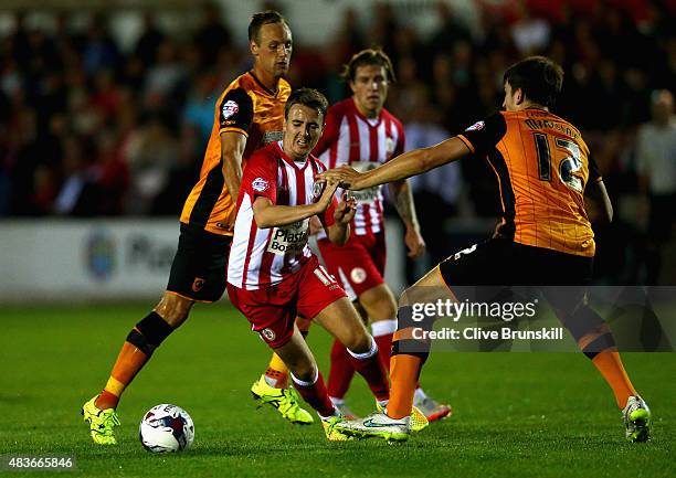 Sean McConville of Accrington Stanley attempts to move past Harry Maguire of Hull City during the Capital One Cup First Round match between...