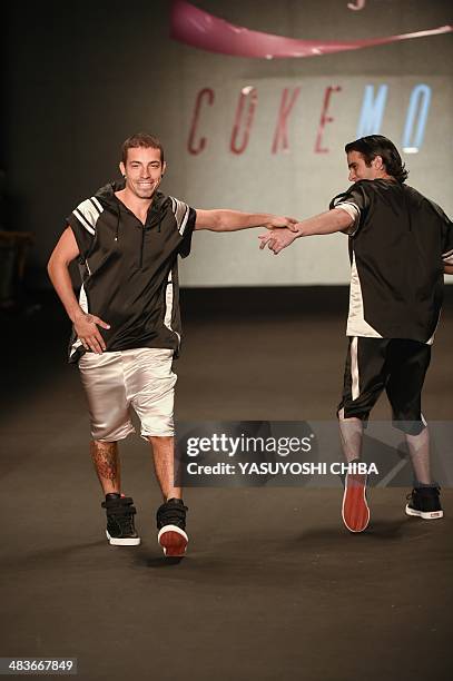 Brazilian musician Di Ferrero and Brazilian singer and actor Fiuk present creations by Coca-Cola jeans during the Fashion Rio 2015 Summer collection...