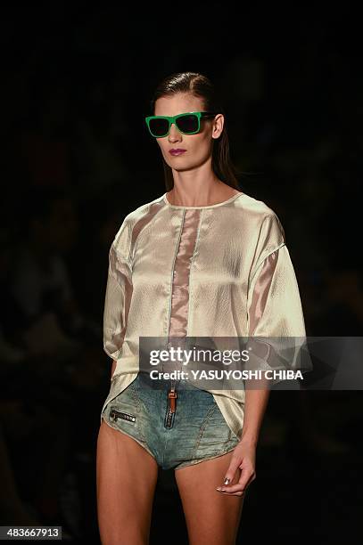 Model presents a creation by Coca-Cola jeans during the Fashion Rio 2015 Summer collection in Rio de Janeiro, Brazil, on April 9, 2014 AFP PHOTO /...