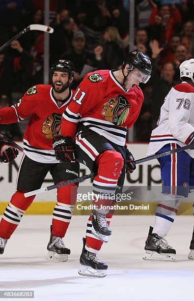 Jeremy Morin and Brandon Bollig of the Chicago Blackhawks celebrate Morin's third period goal against the Montreal Canadiens at the United Center on...