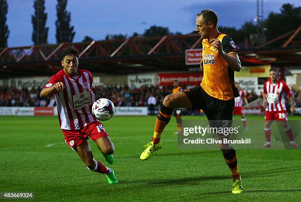 David Meyler of Hull City clears the ball from Matt Crooks of Accrington Stanley during the Capital One Cup First Round match between Accrington...