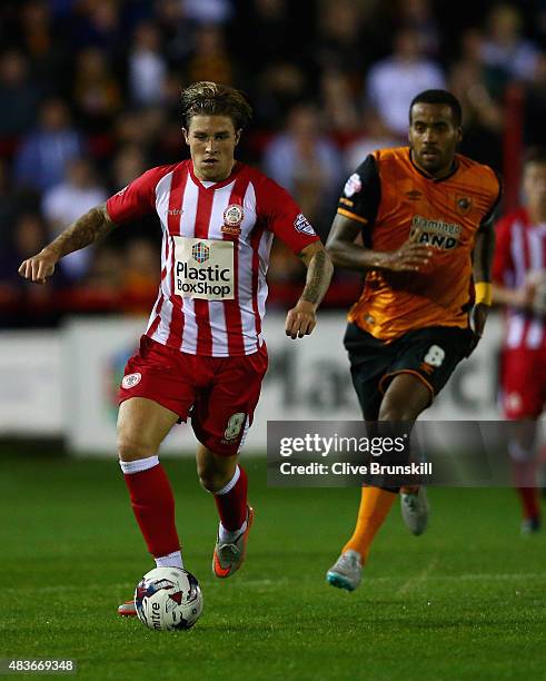 Josh Windass of Accrington Stanley moves away from Tom Huddlestone of Hull City during the Capital One Cup First Round match between Accrington...
