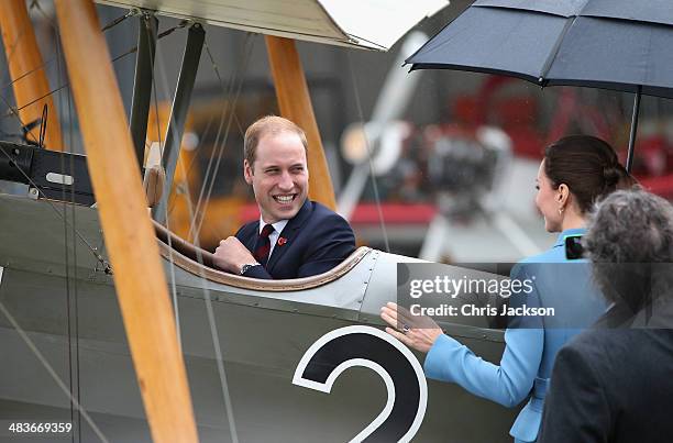 Prince William, Duke of Cambridge turns round and laughs to Catherine, Duchess of Cambridge and Sir Peter Jackson as he sits in a World War I...