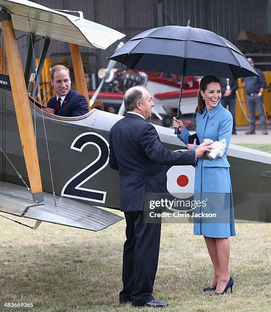 Prince William, Duke of Cambridge turns round and laughs to Catherine, Duchess of Cambridge and Sir Peter Jackson as he sits in a World War I...