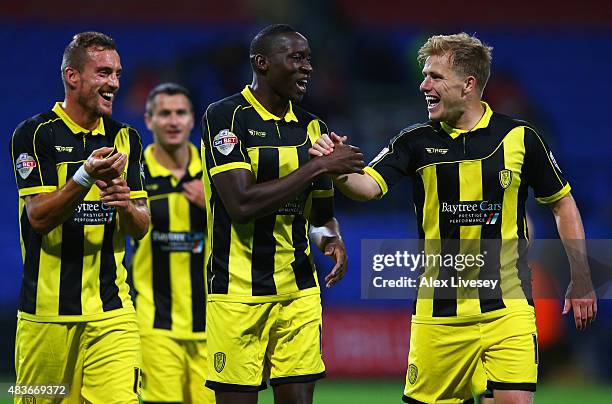 Aurelien Joachim, Lucas Akins and Damien McCrory of Burton Albion celebrate victory after the Capital One Cup first round match between Bolton...