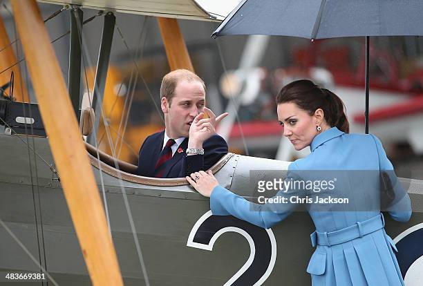 Prince William, Duke of Cambridge turns round and laughs to Catherine, Duchess of Cambridge and Sir Peter Jackson as he sits in a World War I...