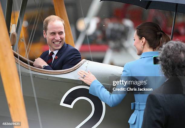 Prince William, Duke of Cambridge turns round and laughs to Catherine, Duchess of Cambridge and Sir Peter Jackson as he sits in a World War I...