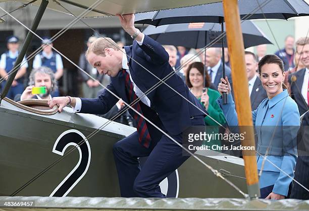 Prince William, Duke of Cambridge climbs in to the cockpit of a WWI bi-plane as Catherine, Duchess of Cambridge looks on during a visit to Omaka...