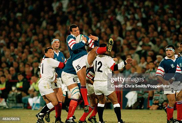 French full-back Jean-Luc Sadourny catches the high ball under pressure from England's Jeremy Guscott during the Rugby Union World Cup 3rd Place...