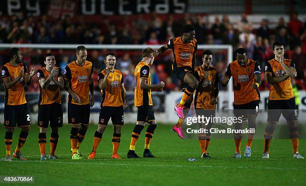 Chuba Akpom leaps above his team mates to celebrate in the penalty shoot out during the Capital One Cup First Round match between Accrington Stanley...