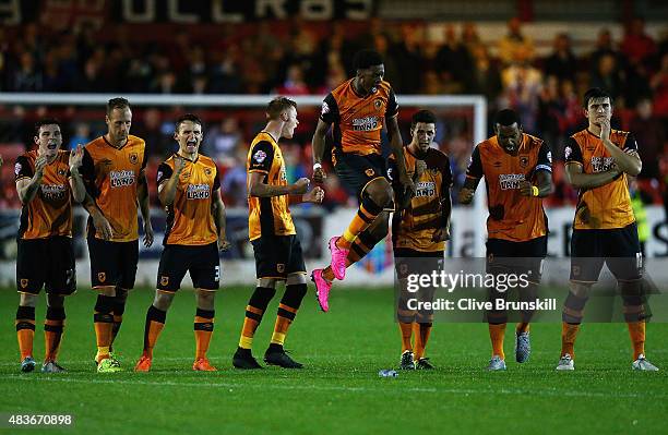 Chuba Akpom leaps above his team mates to celebrate in the penalty shoot out during the Capital One Cup First Round match between Accrington Stanley...