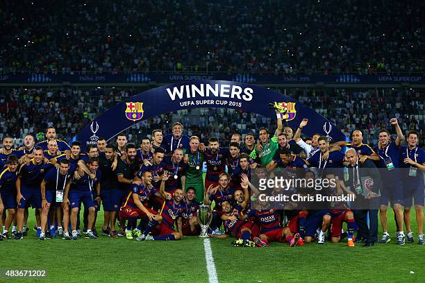 Barcelona pose with the UEFA Cup trophy after victory in the UEFA Super Cup between Barcelona and Sevilla FC at Dinamo Arena on August 11, 2015 in...