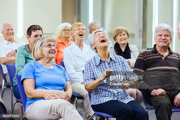 seniors enjoying stage performance - old lecture hall stock pictures, royalty-free photos & images