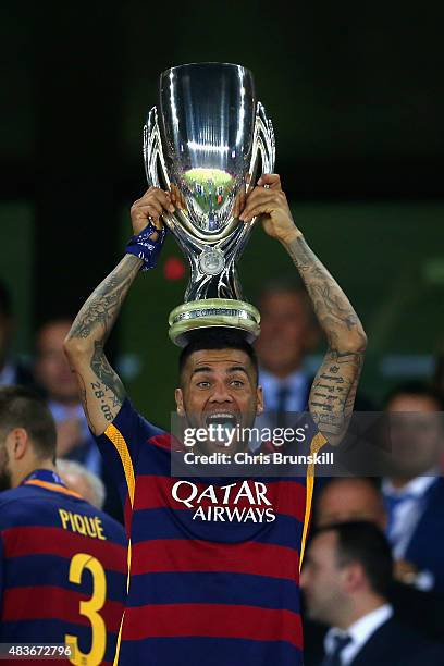 Dani Aleves of Barcelona lifts the UEFA Cup trophy as Barcelona celebrate victoy during the UEFA Super Cup between Barcelona and Sevilla FC at Dinamo...