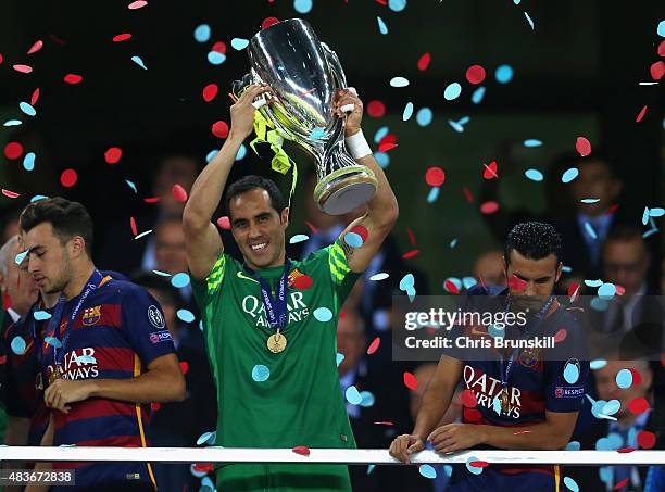 Claudio Bravo of Barcelona lifts the trophy as Pedro of Barcelona looks over the balcony during the UEFA Super Cup between Barcelona and Sevilla FC...