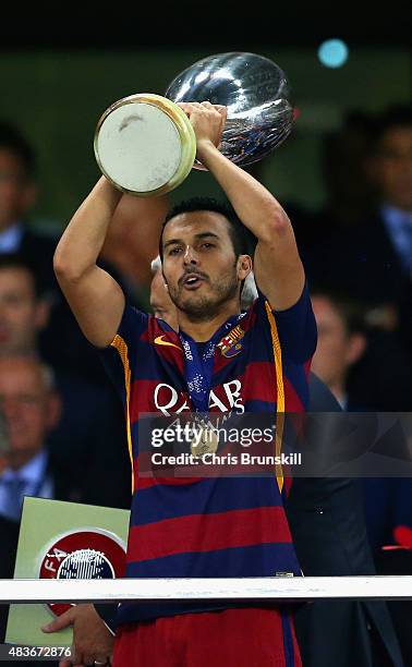 Pedro of Barcelona lifts the UEFA Cup trophy as Barcelona celebrate victoy during the UEFA Super Cup between Barcelona and Sevilla FC at Dinamo Arena...