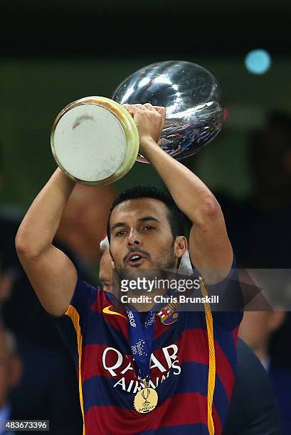 Pedro of Barcelona lifts the UEFA Cup trophy as Barcelona celebrate victoy during the UEFA Super Cup between Barcelona and Sevilla FC at Dinamo Arena...