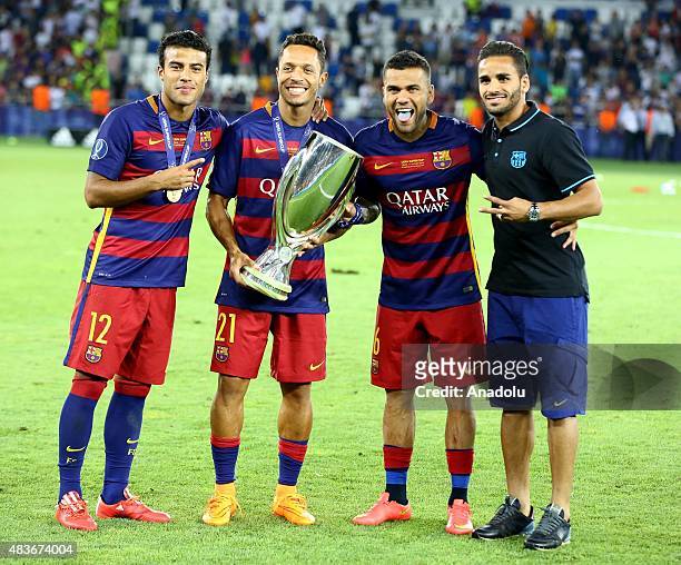 Dani Alves , Adriano and Rafinha celebrate with the UEFA Super Cup after the UEFA Super Cup between Barcelona and Sevilla FC at Dinamo Arena on...