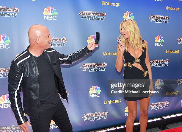 Comedian/TV personality Howie Mandel takes a picture of model/TV personality Heidi Klum before the "America's Got Talent" season 10 taping at Radio...