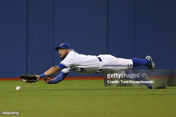 Kevin Pillar of the Toronto Blue Jays dives but cannot get to an RBI double hit by Danny Valencia of the Oakland Athletics in the first inning during...