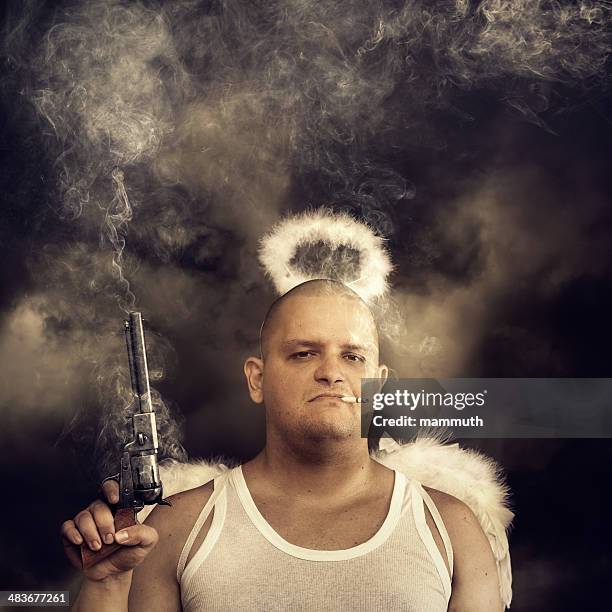 male angel with smoking colt - man angel wings stock pictures, royalty-free photos & images