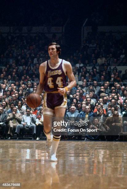 Jerry West of the Los Angeles Lakers dribbles the ball up court against the New York Knicks during an NBA basketball game circa 1969 at Madison...