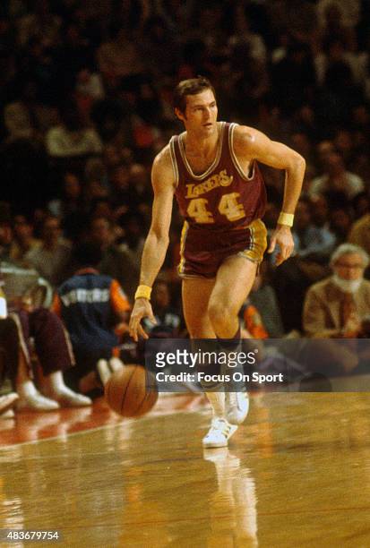 Jerry West of the Los Angeles Lakers dribbles the ball up court against the Baltimore Bullets during an NBA basketball game circa 1972 at the...