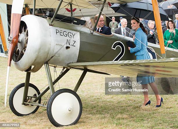 Catherine, Duchess of Cambridge looks at Prince William, Duke of Cambridge sit in a plane at a WW1 commemorative and Flying Day at Omaka Aviation...