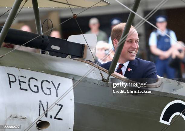 Prince William, Duke of Cambridge turns round and laughs to Catherine, Duchess of Cambridge and Sir Peter Jackson as he sits in a World War I...