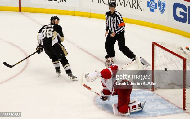 Jussi Jokinen of the Pittsburgh Penguins scores against Jonas Gustavsson of the Detroit Red Wings during the shootout at Consol Energy Center on...