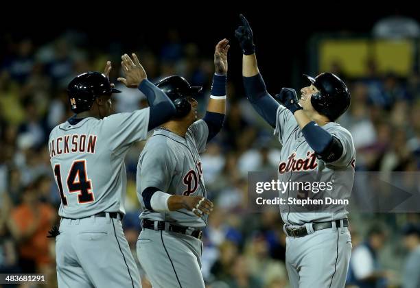 Nick Castellanos, Victor Martinez, and Austin Jackson of the Detroit Tigers celebrate after all three score on Castellanos' three run home run in the...