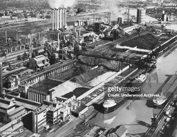 Ford Motor Company's River Rouge plant showing the stockpiles of iron ore, coal and limestone which supply the blast furnaces, foundry and powerhouse...