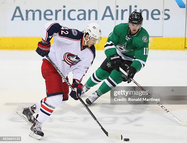 Artem Anisimov of the Columbus Blue Jackets skates the puck against Dustin Jeffrey of the Dallas Stars in the third period at American Airlines...