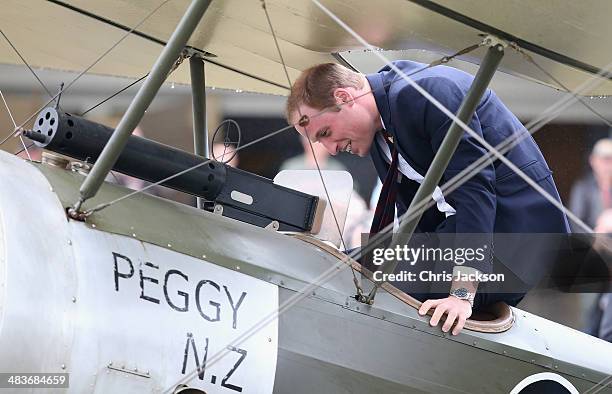 Prince William, Duke of Cambridge turns round and laughs to Catherine, Duchess of Cambridge and Sir Peter Jackson as he sits in a World War I...