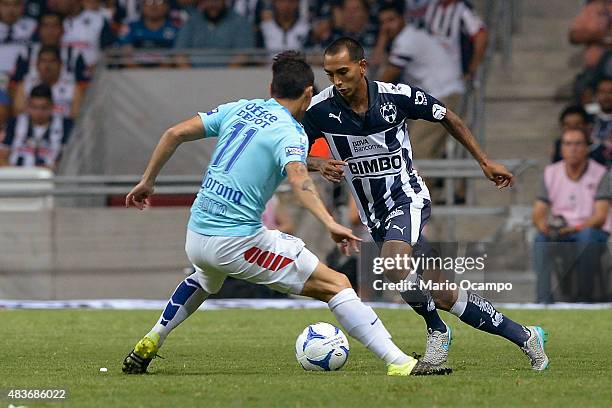 Edgar Castillo of Monterrey tries to pass the ball over the mark of Ruben Botta of Pachuca during a 4th round match between Monterrey and Pachuca as...