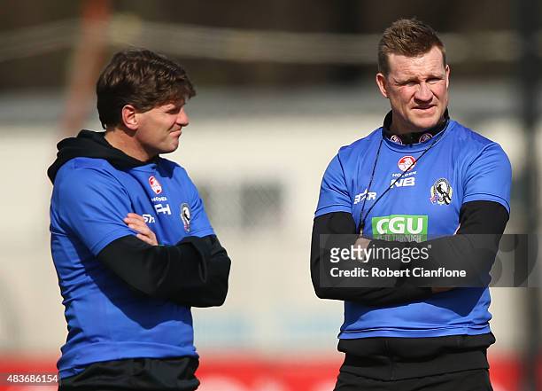 Assistant coach Robert Harvey and coach Nathan Buckley look on during a Collingwood Magpies AFL training session at Westpac Lounge, Westpac Centre on...