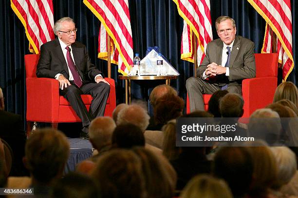 Republican presidential candidate Jeb Bush speaks with former U.S. Ambassador to the U.K. Robert Tuttle at the Ronald Reagan Presidential Library...