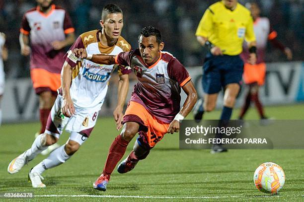 Enson Rodriguez of Venezuela's Carabobo FC, vies for ball with Matheus Uribe of Colombias Tolima, during their Copa Sudamericana 2015 football match...